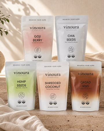 Five packages of vinoura products on a wooden surface with a neutral background