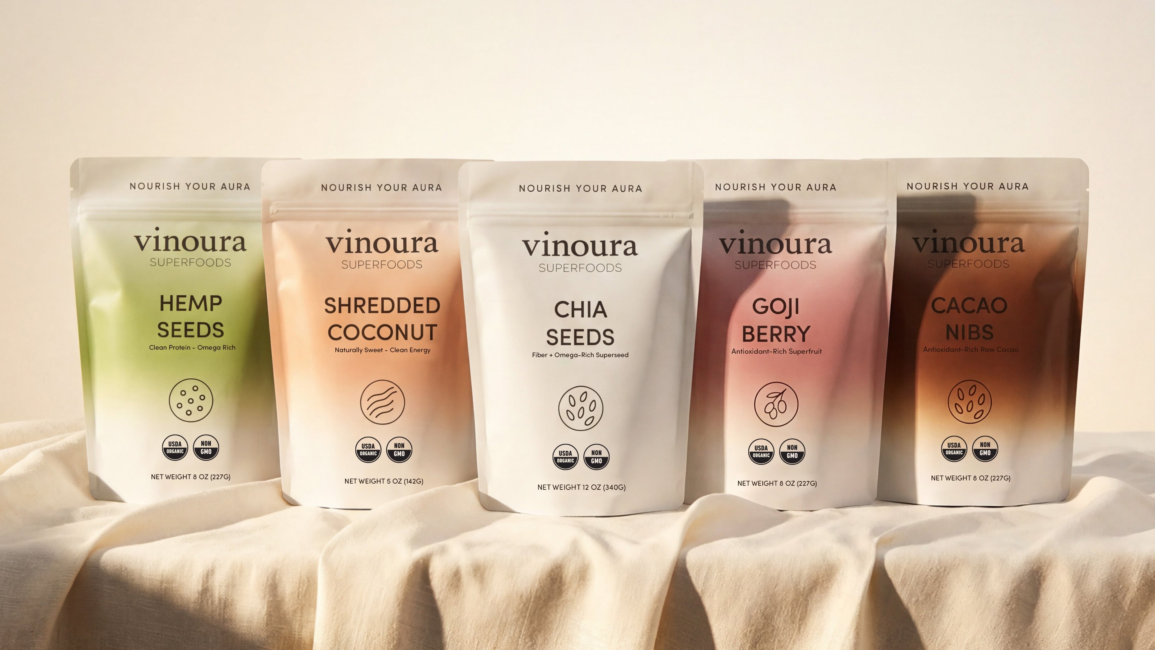 Five packages of vinoura products on a beige fabric backgroundslider_item_CyJhcR