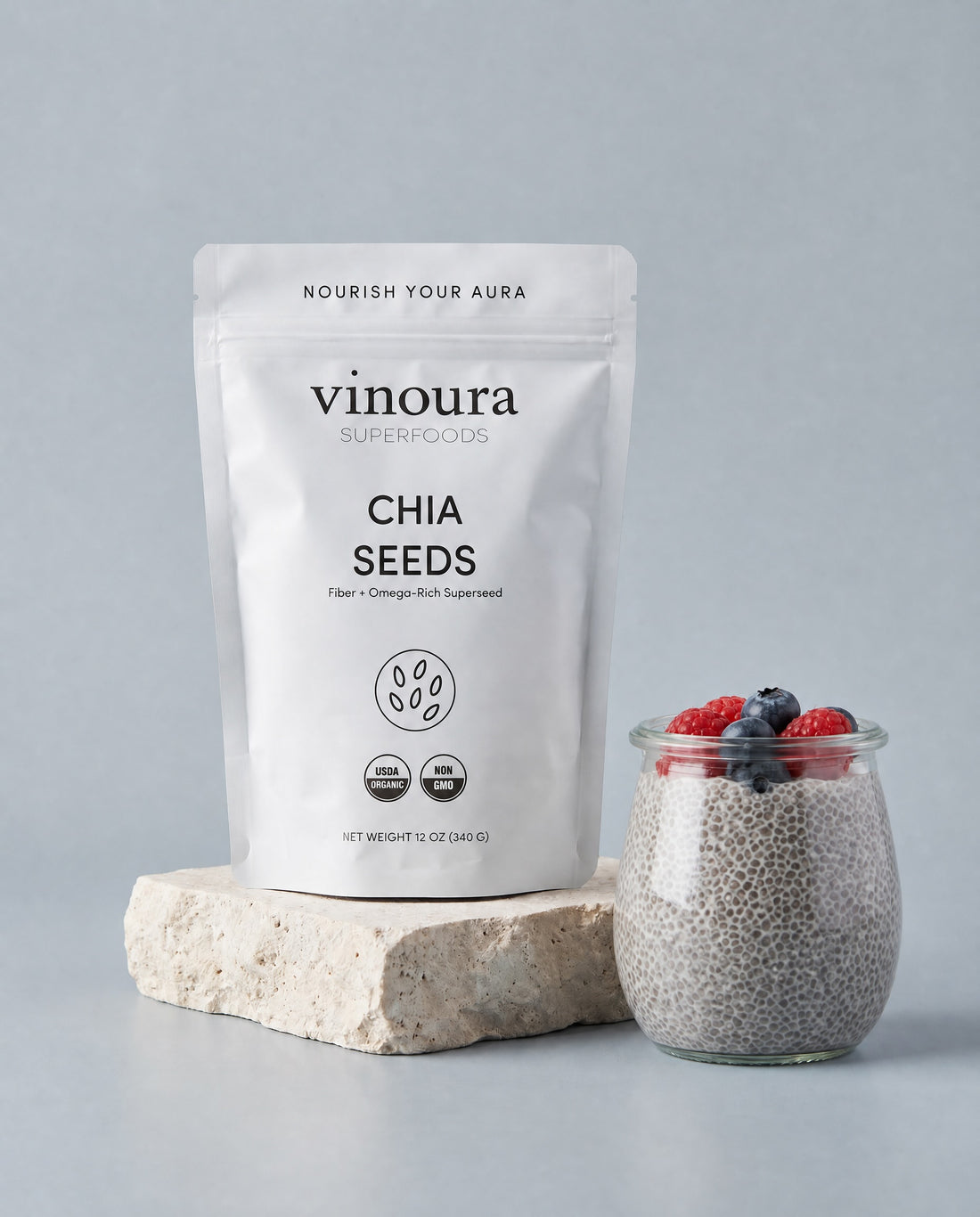 Vinoura chia seeds packaging with a jar of chia seeds topped with berries on a gray background